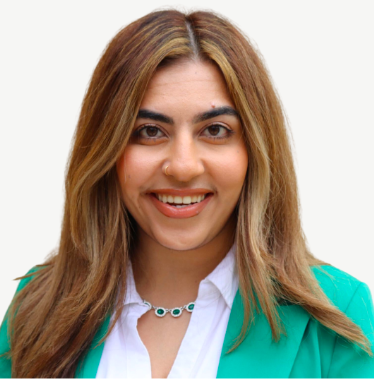 Headshot of smiling woman in green jacket with white shirt, long brown hair